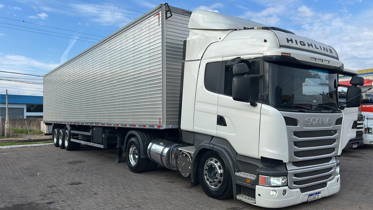 Caminhão Scania da frota JHOW Transportes estacionado com semirreboque